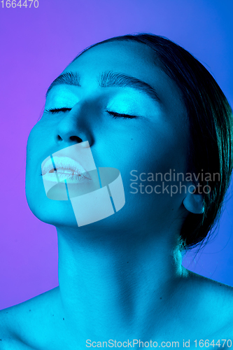 Image of Beautiful east woman portrait isolated on gradient studio background in neon light, monochrome