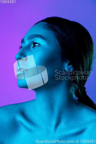 Image of Beautiful east woman portrait isolated on gradient studio background in neon light, monochrome