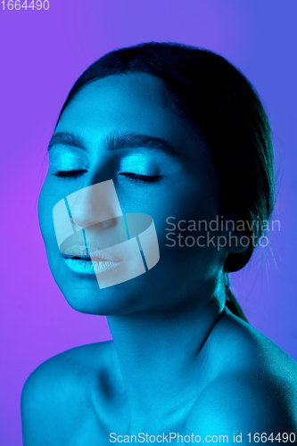 Image of Beautiful east woman portrait isolated on gradient studio background in neon light, monochrome