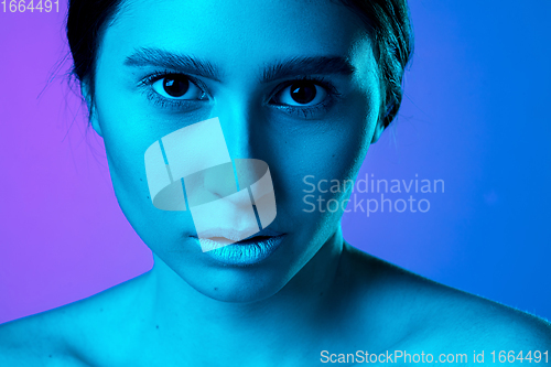 Image of Beautiful east woman portrait isolated on gradient studio background in neon light, monochrome