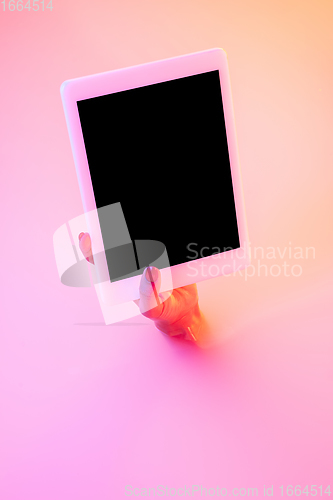 Image of Close up female hand gesturing from the milk bath with soft glowing in neon light
