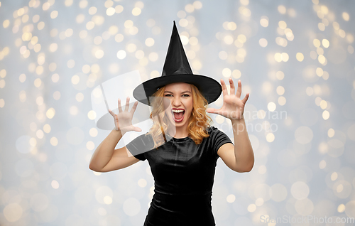 Image of scary woman in black halloween costume of witch