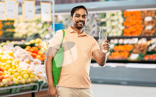 Image of man with bag for food shopping and glass bottle