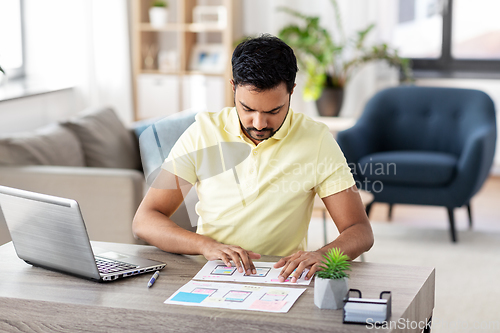 Image of ui designer working on user interface at home
