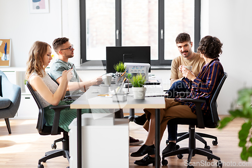 Image of team of startuppers drinking coffee at office