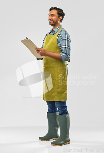 Image of happy indian gardener or farmer with clipboard