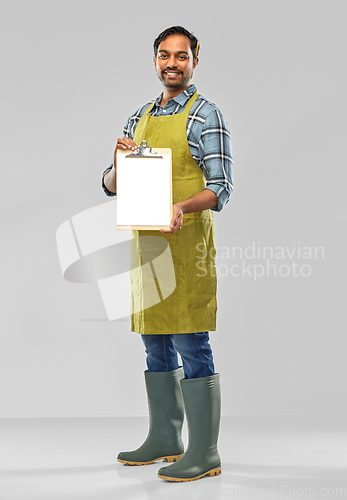 Image of happy indian gardener or farmer with clipboard