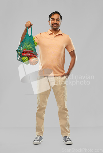 Image of happy indian man with food in reusable net tote