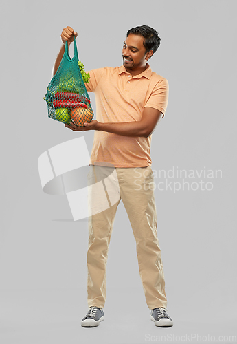 Image of happy indian man with food in reusable net tote