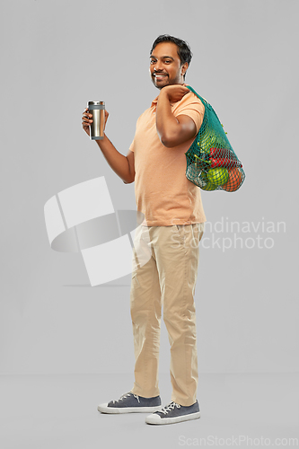 Image of man with food in bag and tumbler or thermo cup