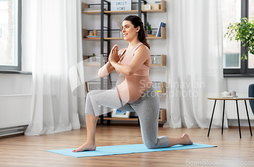 Image of happy pregnant woman doing sports at home