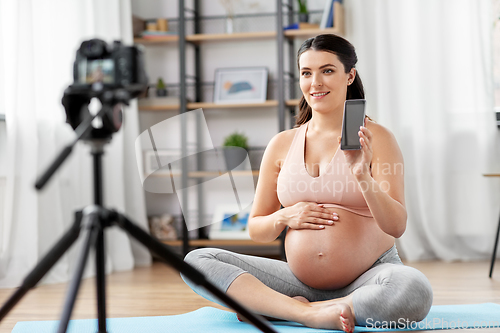 Image of happy pregnant woman blogger recording yoga video