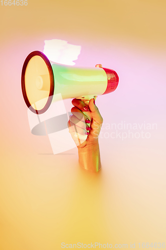 Image of Close up female hand gesturing from the milk bath with soft glowing in neon light