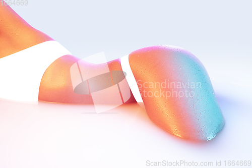 Image of Close up female body in the milk bath with soft glowing in neon light