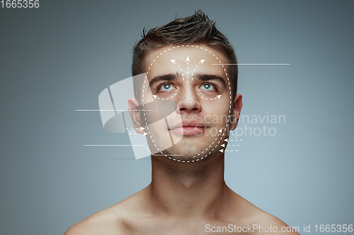 Image of Beautiful male face with lifting up arrows isolated on grey background