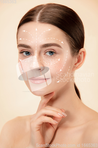 Image of Beautiful female face with lifting up arrows isolated on studio background