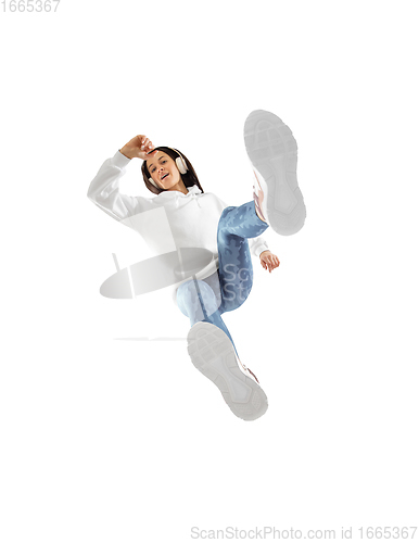 Image of Young stylish woman in modern street style outfit isolated on white background, shot from the bottom