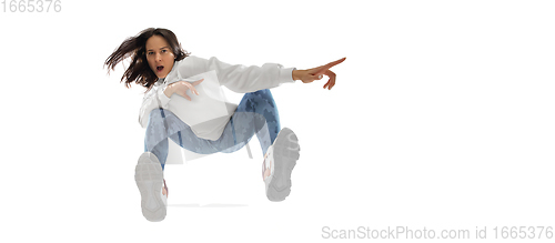 Image of Young stylish woman in modern street style outfit isolated on white background, shot from the bottom