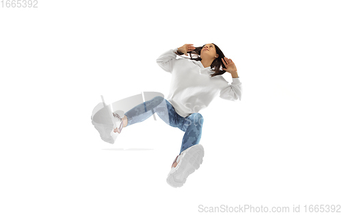 Image of Young stylish woman in modern street style outfit isolated on white background, shot from the bottom
