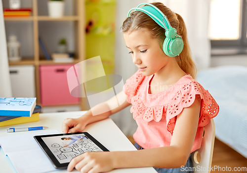Image of girl in headphones with tablet computer at home