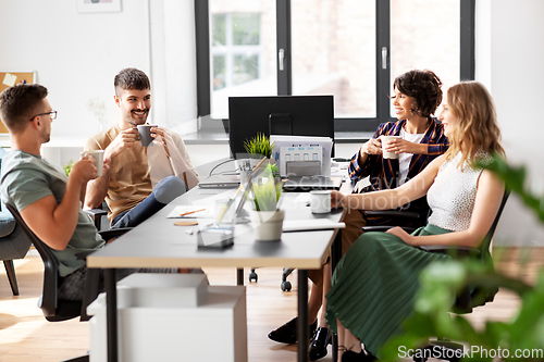 Image of team of startuppers drinking coffee at office
