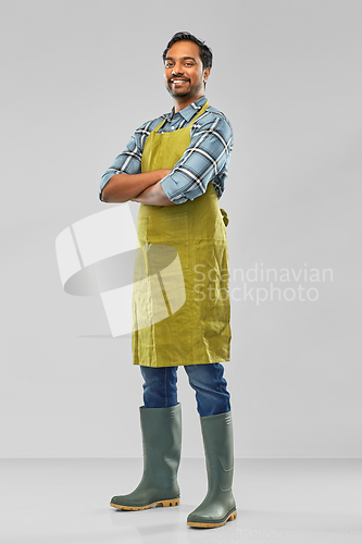 Image of happy indian male gardener or farmer in apron