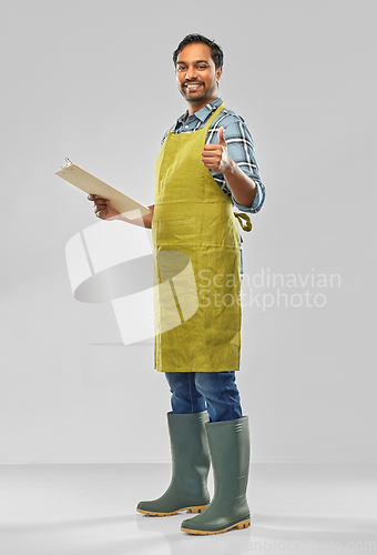 Image of happy indian gardener or farmer with clipboard