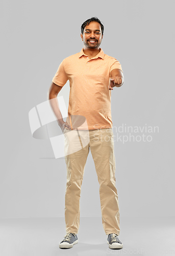 Image of smiling indian man pointing fingers at you