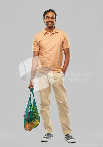 Image of happy indian man with food in reusable net tote