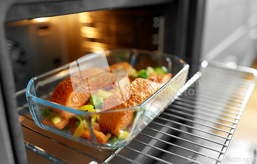 Image of food cooking in baking dish in oven at home