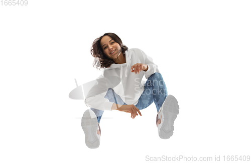 Image of Young stylish woman in modern street style outfit isolated on white background, shot from the bottom