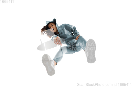 Image of Young stylish woman in modern street style outfit isolated on white background, shot from the bottom