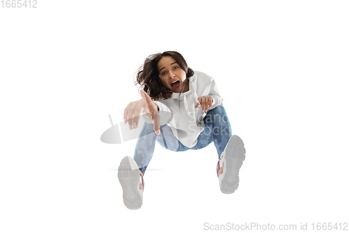 Image of Young stylish woman in modern street style outfit isolated on white background, shot from the bottom