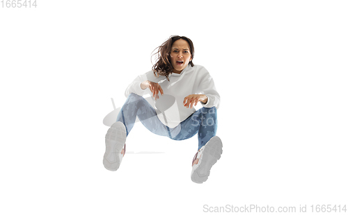 Image of Young stylish woman in modern street style outfit isolated on white background, shot from the bottom