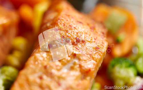 Image of close up of baked salmon fish with vegetables