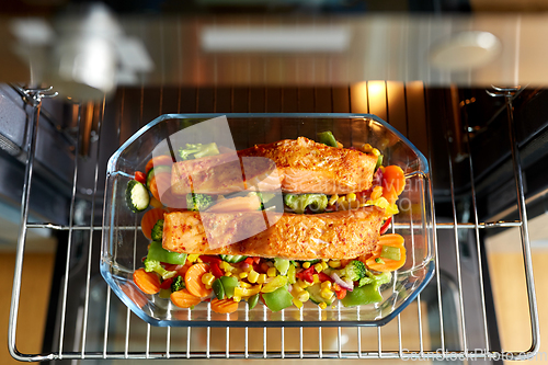 Image of food cooking in baking dish in oven at home