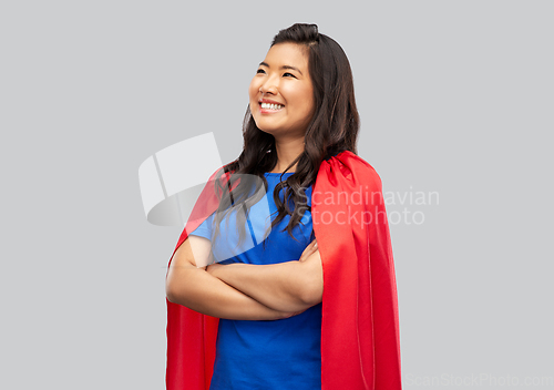Image of happy asian woman in red superhero cape