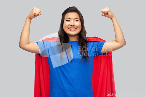 Image of happy asian woman in red superhero cape