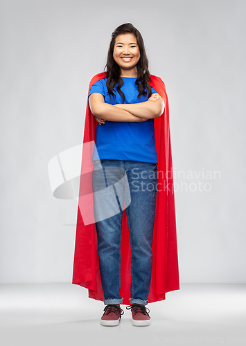 Image of happy asian woman in red superhero cape