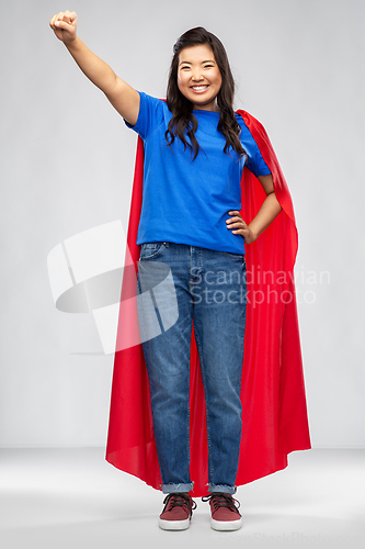 Image of happy asian woman in red superhero cape