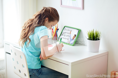 Image of girl with tablet pc having online lesson at home