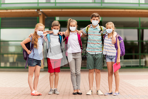 Image of group of students in masks hugging over school