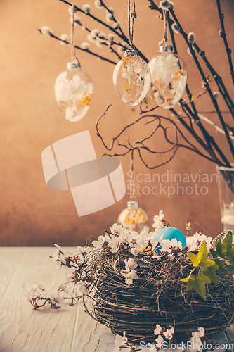 Image of Nest with Easter eggs and blooming branches with pussy willow branches decorated