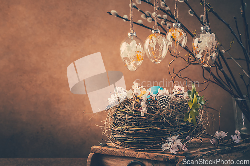 Image of Nest with Easter eggs and blooming branches with pussy willow branches decorated