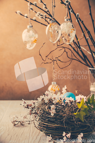 Image of Nest with Easter eggs and blooming branches with pussy willow branches decorated