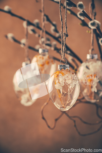 Image of Holidays and Easter concept - close up of pussy willow branches decorated with Easter eggs