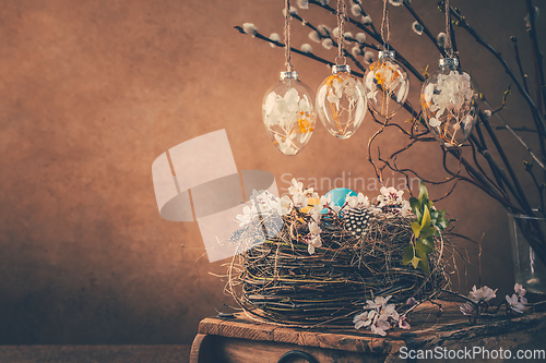 Image of Nest with Easter eggs and blooming branches with pussy willow branches decorated