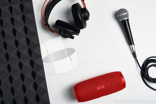 Image of Microphone, headphones and portable stereo speaker on on white background with copy space and acoustic foam panel