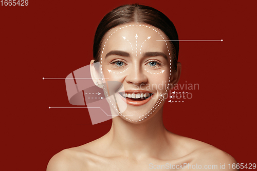 Image of Beautiful female face with lifting up arrows isolated on red background