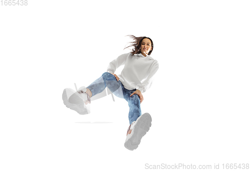 Image of Young stylish woman in modern street style outfit isolated on white background, shot from the bottom